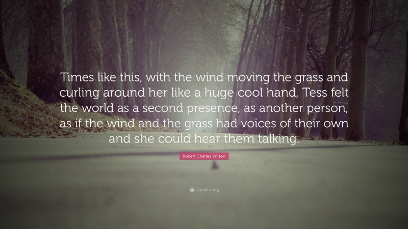 Robert Charles Wilson Quote: “Times like this, with the wind moving the grass and curling around her like a huge cool hand, Tess felt the world as a second presence, as another person, as if the wind and the grass had voices of their own and she could hear them talking.”
