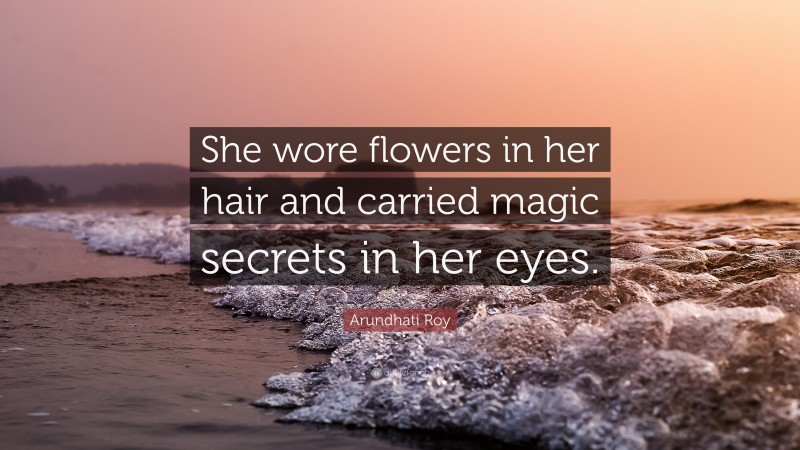 Arundhati Roy Quote: “She wore flowers in her hair and carried magic secrets in her eyes.”