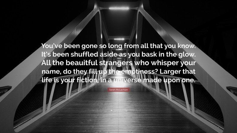Sarah McLachlan Quote: “You’ve been gone so long from all that you know. It’s been shuffled aside as you bask in the glow. All the beauitful strangers who whisper your name, do they fill up the emptiness? Larger that life is your fiction, in a universe made upon one.”
